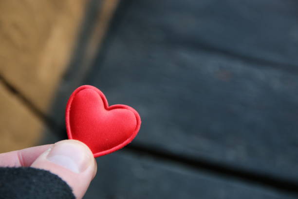 istock Human hand holding red toy heart. Valentine's Day idea. 1456030781