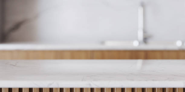 istock Panorama with white modern kitchen countertop closeup for product placement. Blurred background. 1456031095