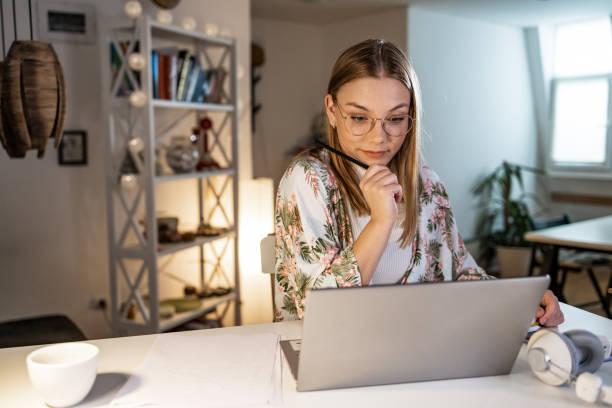 istock Young woman working on a laptop 1456031286