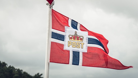 A Norwegian post flag on cloudy day