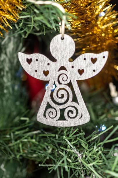 istock Decorated hanging angel cdr on green grass, vertical shot 1456033201