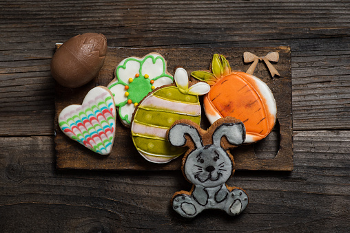 Sweets, pastries, gingerbread cookies on a wooden Easter table-Easter bunny, carrot, egg, flower, heart.
