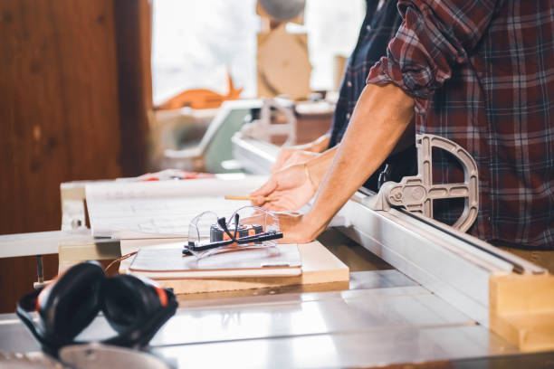 istock Couple of young carpenter working together 1456033745