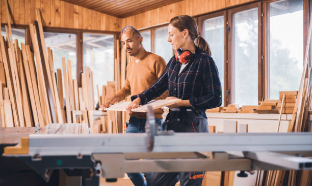 istock Couple of young carpenter working together 1456033765