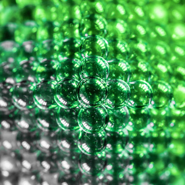 istock Macro shot of lit green and grey marbles forming a pyramid 1456034112