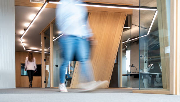 istock Business People Walking Down The Hallway 1456034172