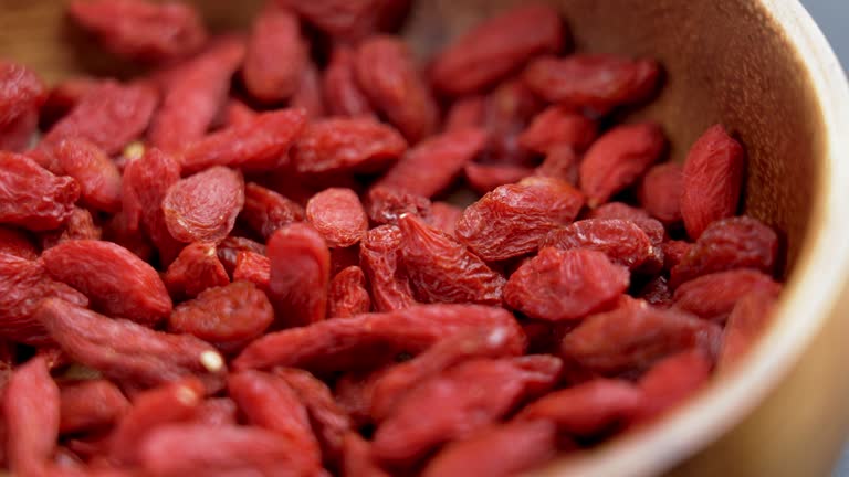 Dried red wolfberries (goji berry) in wooden rustic bowl