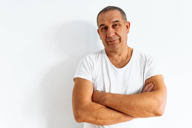 portrait of attractive middle-aged with emotion of doubt and disbelief portrait of attractive middle-aged man with brown eyes, muscular build, wearing white t-shirt, with skeptical expression, dissatisfied emotion, doubtful opinion confusion raised eyebrows human face men stock pictures, royalty-free photos & images