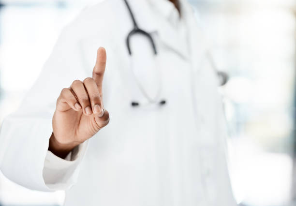 istock Hand, healthcare and touchscreen with a doctor black man using a technology interface in a hospital. Future, innovation and research with a medicine professional working in a clinic for medical 1456037042