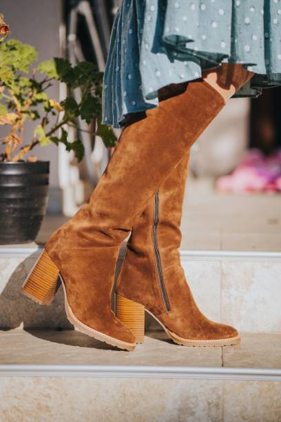 istock Legs wearing suede boots on the street 1456037113