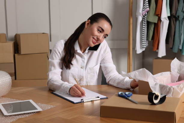 istock Seller talking on phone while working in office. Online store 1456038630