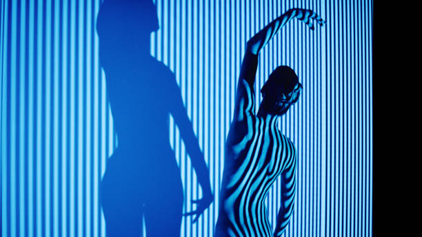 istock A woman practices ballet positions on a wall with straps. 1456039382