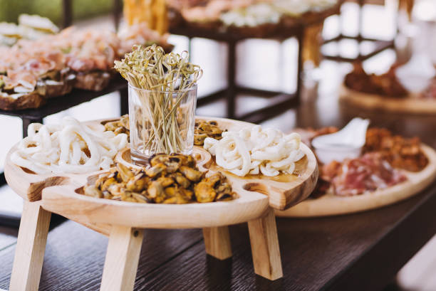 istock Raw seafood mix in a wooden plate. 1456040054