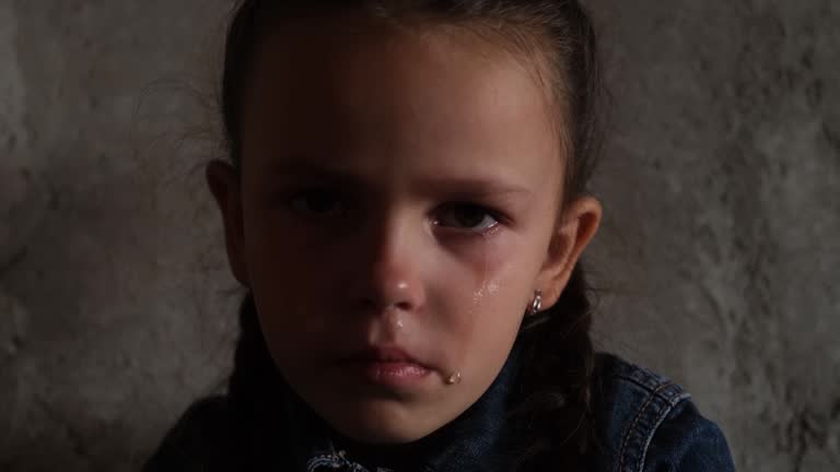 Portrait of a crying Ukrainian child, rocket attacks on cities. War in Ukraine. Upset child.