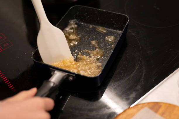 istock Melt a sugar sauce in a frying pan, sugar caramelizing 1456040994
