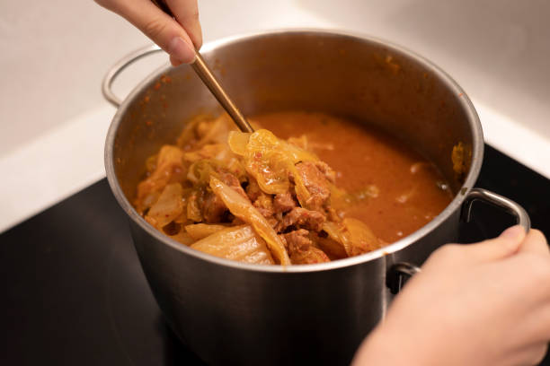 istock Cooking kimchi stew with a pot, stir the spicy stew with a spoon 1456041311