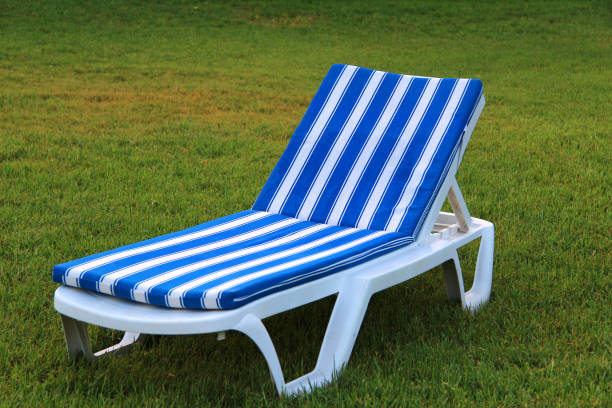 Sun lounger in the green garden