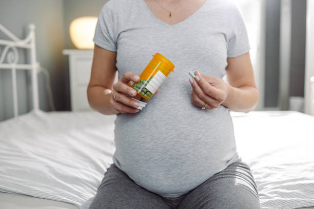 istock Pregnant woman taking a medicine 1456041739