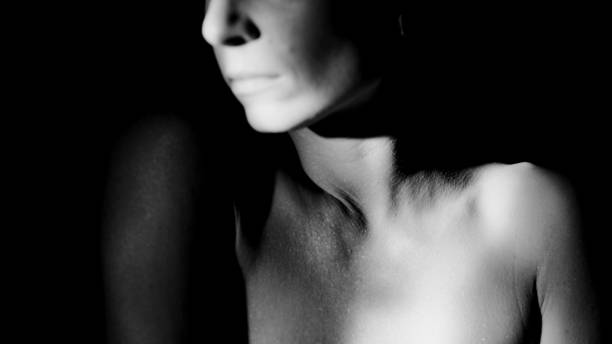 istock Female body and face in light. 1456042552