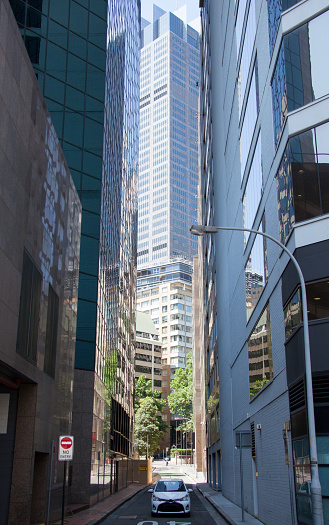 The one way narrow street and a tall skyscraper in Sydney downtown (New South Wales).