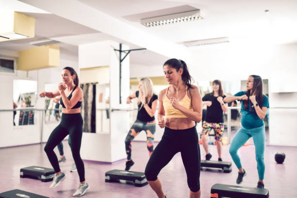 istock Senior Athletic Females Doing Tae Bo Training With Steppers 1456044400
