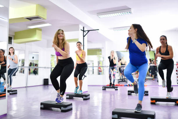 istock Female Athletes Of Different Races Using Steppers In Gym 1456045626