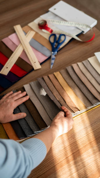 istock Close-up Designer woman choosing from fabric catalog 1456045839