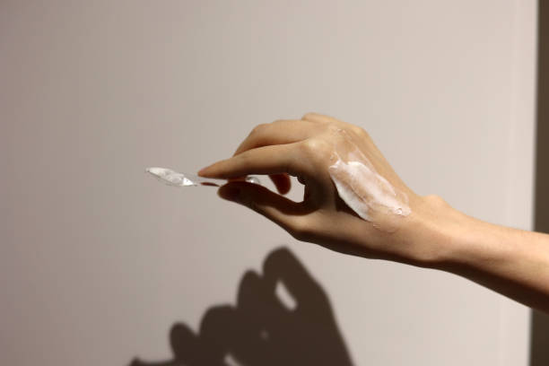 istock Applying cosmetic cream on the hands with spatula 1456045991