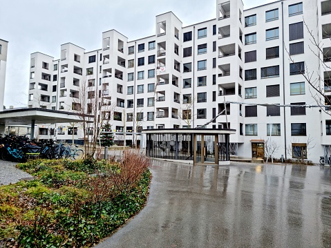 Triemli 1 Zurich is a residential complex planned by  Hauenstein La Roche Schedler Architects (HLS). The buildings have been completed in 2017. Triemli 1 includes 167 apartments and 6 commercial premises. The Image was captured during winter season on a rainy day.
