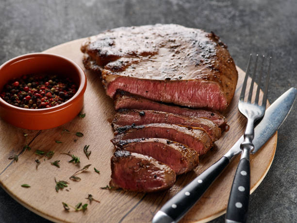 istock Grilled beef heart steak with pepper on a wooden board. 1456047938