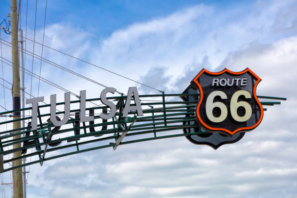 Route 66 Sign in Tulsa, Oklahoma A black and white road sign of the historic Route 66 against blue sky. tulsa landmark stock pictures, royalty-free photos & images