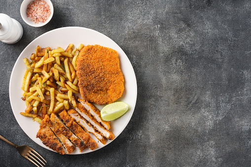 Pork cutlet with french fries, top view