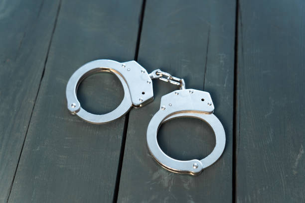 istock Metal handcuffs on the table 1456051161