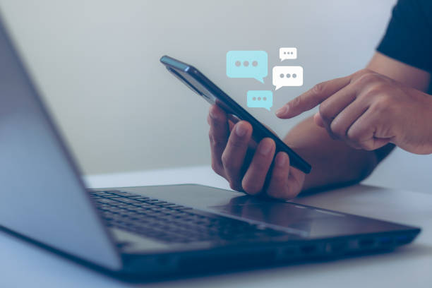 istock Man hand using smartphone typing, chatting conversation in chat box icons pop up on application in response to communication, Communication Digital Web, social network. Social media marketing concept. 1456052212