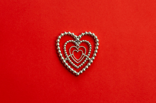 Decorative heart on red background isolated, flat lay, Valentine's day concept.