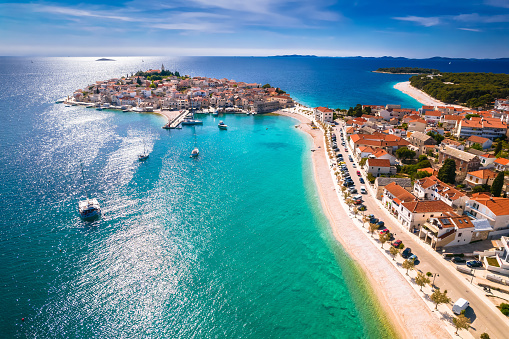 Scenic town and beaches of Primosten aerial view, turquoise archipelago and historic architecture of Croatia