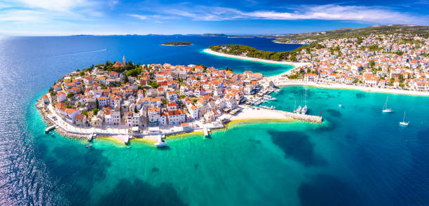 Scenic town and beaches of Primosten aerial panoramic view Scenic town and beaches of Primosten aerial panoramic view, turquoise archipelago and historic architecture of Croatia croatia stock pictures, royalty-free photos & images