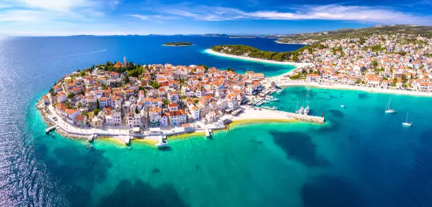 Scenic town and beaches of Primosten aerial panoramic view, turquoise archipelago and historic architecture of Croatia