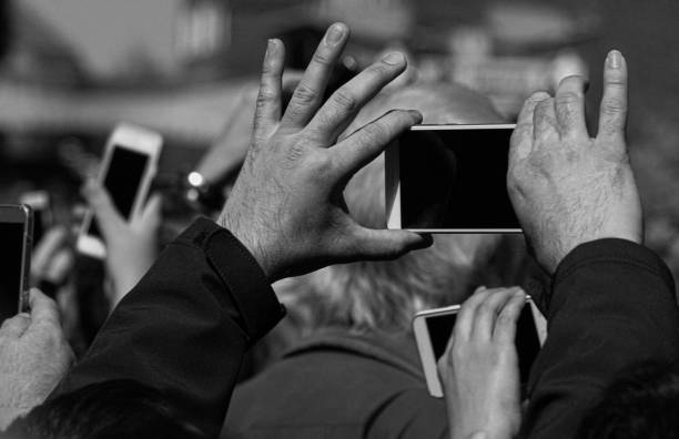 Cropped hands photographing with mobile phone