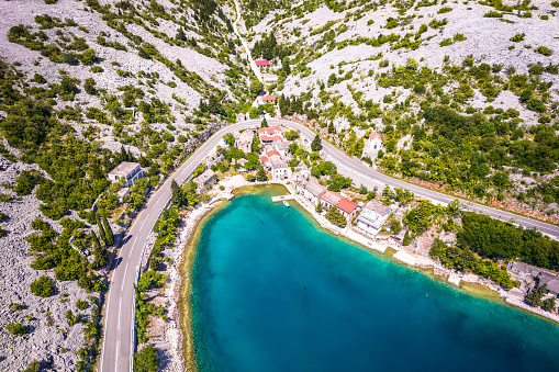 Scenic fishermen village Tribanj under Velebit mountain aerial view, archipelago of Adriatic sea in Croatia