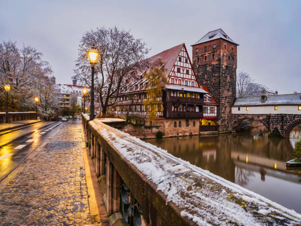 Max Bridge, half timbered houses and the water tower at dusk in Nuremberg, Germany