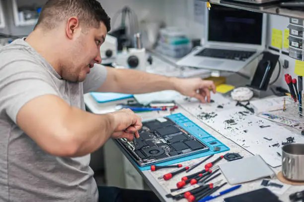 Photo of Servicing, repairing, cleaning, maintaining computers in an electronics repair shop