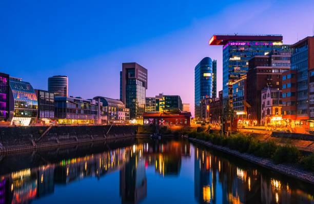 istock Skyline of Dusseldorf harbor at dusk reflected in the water 1456057721