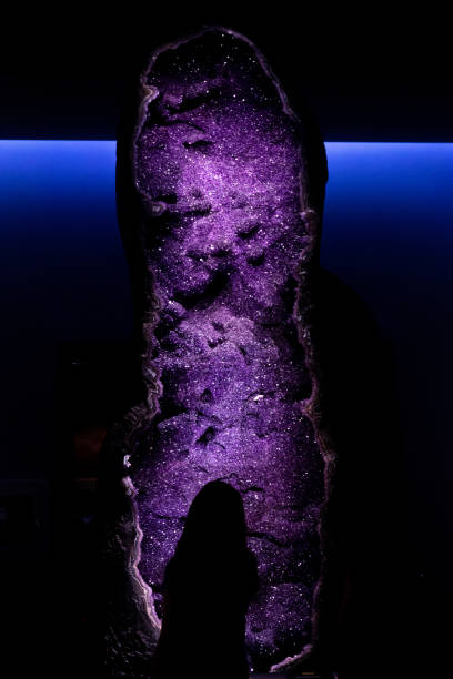 istock Vertical shot of amethyst geode against a dark and blue background 1456058543