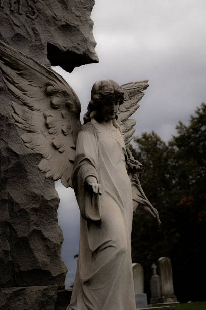 istock Vertical shot of an angel statue under a gloomy sky 1456058549