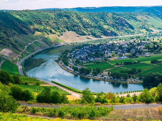 istock Beautiful landscape with a river under a cloudy sky captured from a grassy hilltop 1456058553
