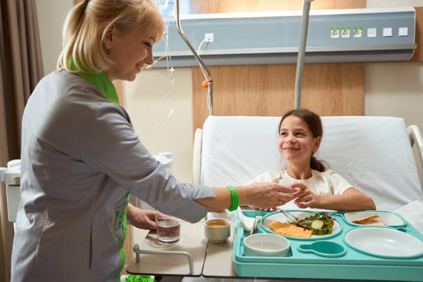 istock Nurse giving medicine to patient while eating 1456058651