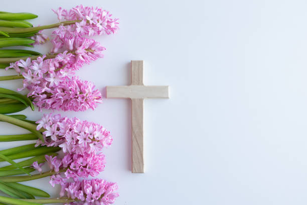 istock Wood cross and pink flowers 1456059786