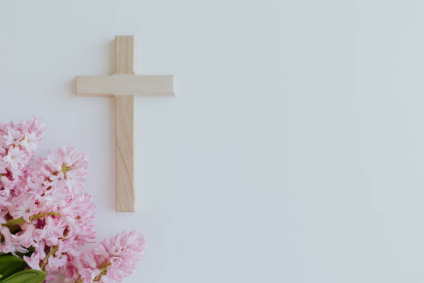 istock Wood cross and pink flowers 1456059787