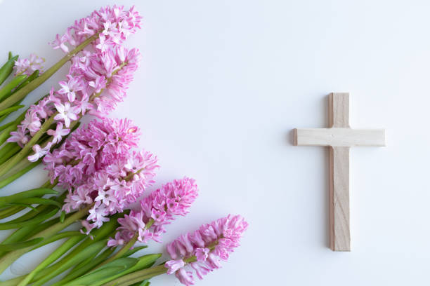 istock Wood cross and pink flowers 1456059789